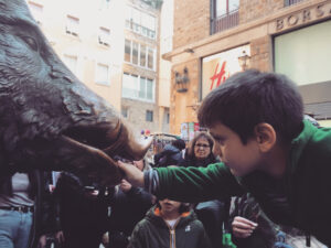 Florence' Porcellino Fountain: my son rubbing the piglet's nose!